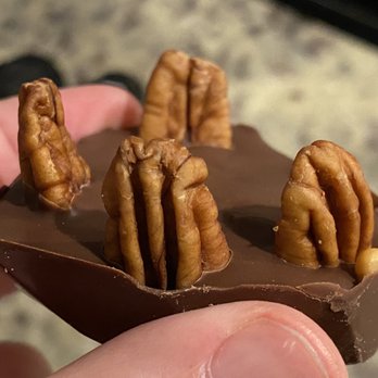 Bougie Boozy Bears - a hand holding a piece of chocolate - Beer, Wine & Spirits Near Me - Carrollton, Texas