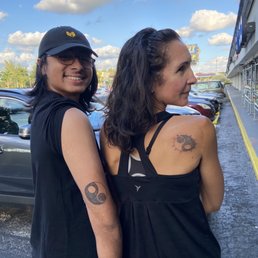 My youngest son and I with matching tattoos. Nathan added my son's names to a design my older son created. My youngest son and I with matching tattoos. Nathan added my son's names to a design my older son created.