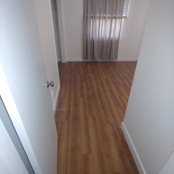 Empire Luxury Flooring - View of the vinyl planks from the perspective of the door of the room. - Flooring Near Me Empire Luxury Flooring - View of the vinyl planks from the perspective of the door of the room. - Flooring Near Me