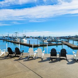 Saltwater Inn - Marina front patio with chairs to enjoy the views of the docks and boats.
