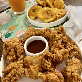 El Castillo De Jagua Restaurant - Fried Boneless Chicken Cracklings with dipping sauce & a side of Fried Plantains (tostones) - Latin American Near Me - New York, New York El Castillo De Jagua Restaurant - Fried Boneless Chicken Cracklings with dipping sauce & a side of Fried Plantains (tostones) - Latin American Near Me - New York, New York