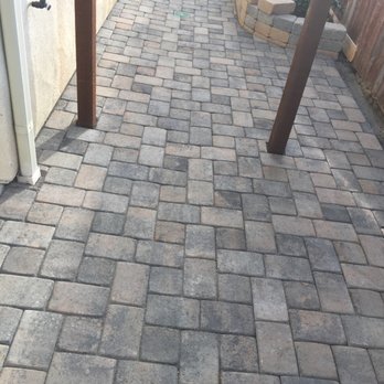 Red Dog Landscape - a brick walkway with a wooden post - Landscaping Near Me Red Dog Landscape - a brick walkway with a wooden post - Landscaping Near Me