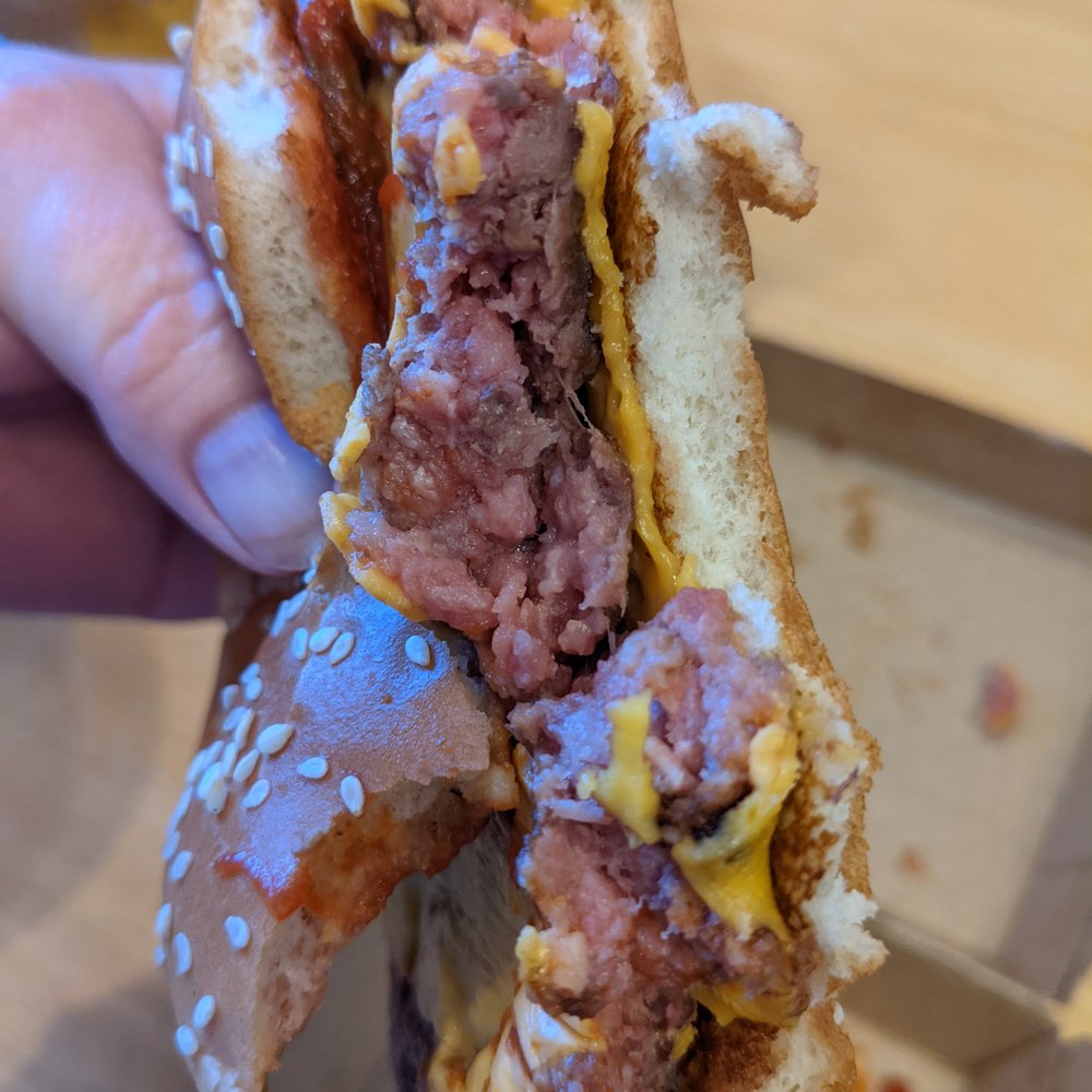 McDonald's - a hand holding a half eaten hamburger - Fast Food Near Me - Brantford, Ontario McDonald's - a hand holding a half eaten hamburger - Fast Food Near Me - Brantford, Ontario