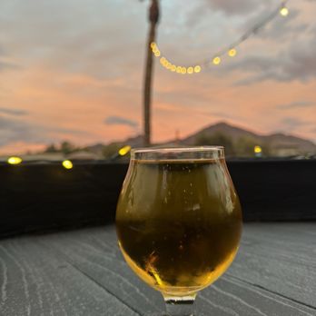 The Attic Ale House - a glass of beer on a table - Gastropubs Near Me - Phoenix, Arizona