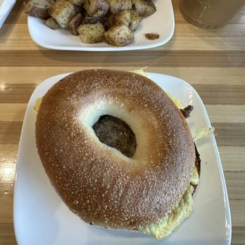 Cafe XIX - Egg and sausage sandwich on a bagel with garlic butter potatoes - Cafes Near Me - Seneca Falls, New York