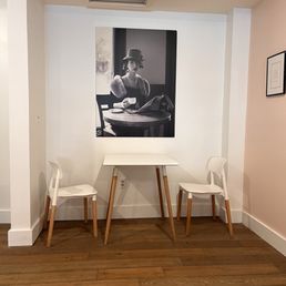 a photograph of a woman seated at a table a photograph of a woman seated at a table