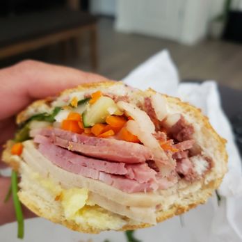 Saigon Corner - a hand holding a half eaten sandwich - Sandwiches Near Me - Sacramento, California Saigon Corner - a hand holding a half eaten sandwich - Sandwiches Near Me - Sacramento, California