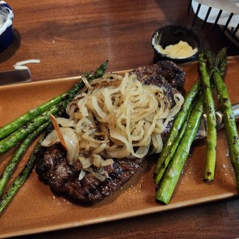 Tony Roma's - New York Steak with grilled onions and asparagus - Barbeque Near Me - Anaheim, California Tony Roma's - New York Steak with grilled onions and asparagus - Barbeque Near Me - Anaheim, California
