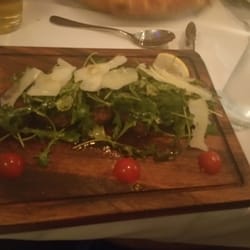 Buon Appetito - Sliced sirloin covered with greens tossed in light balsamic and olive oil topped with fresh parmesan