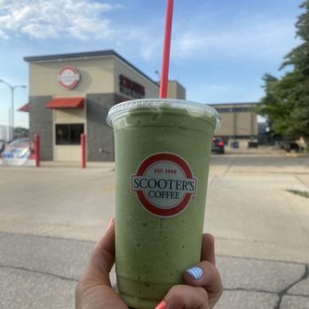 Scooter's Coffee - a hand holding a green smoothie - Coffee & Tea Near Me - Spencer, Iowa Scooter's Coffee - a hand holding a green smoothie - Coffee & Tea Near Me - Spencer, Iowa