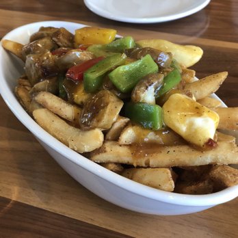 The Vic Bar + Kitchen - Bangers. Not a bad starter. Sausage is zesty, gravy peppery, fries perfectly fried. - New American Near Me - Buckeye, Arizona