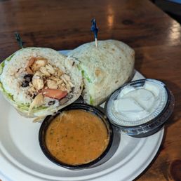 Chicken, rice wrap with sour cream and spicy dip. Delicious