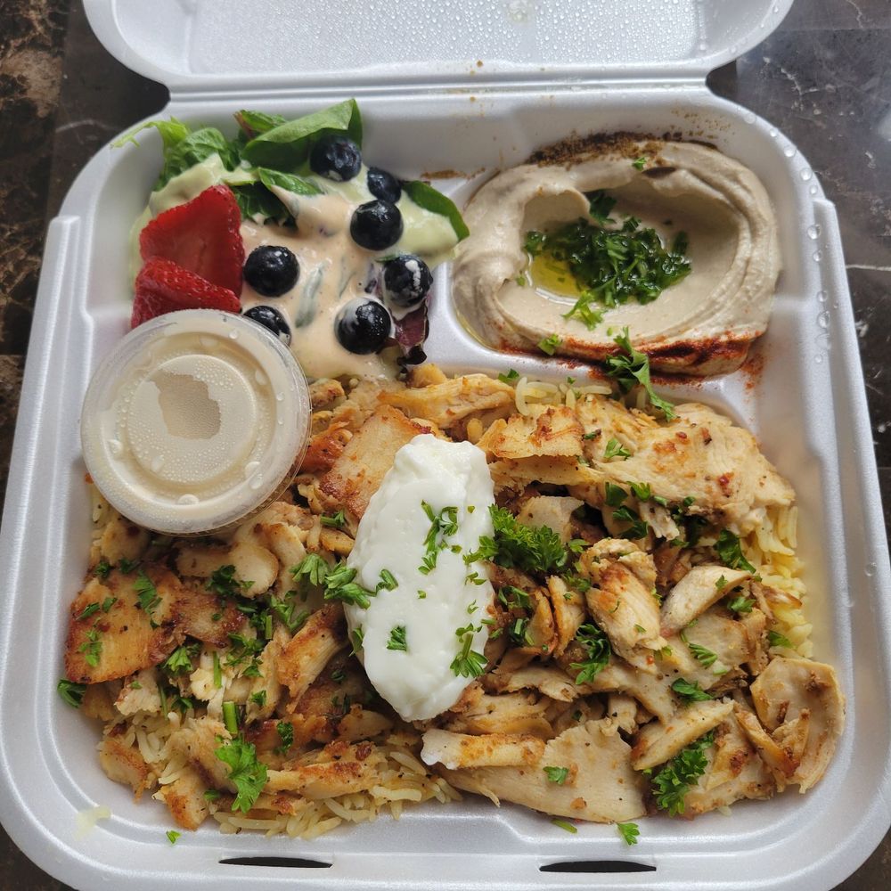 The chicken shwarma plate in the to go container The chicken shwarma plate in the to go container