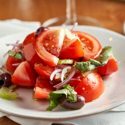 Casa Mia - Vine ripe organic tomato salad with red onions, Kalamata, olives, basil, celery, and extra-virgin olive oil
