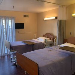 Pine Ridge Care Center - Facility room. Each room has individual television and personal drawers. Very comfortable environment.