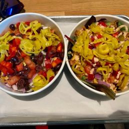 Salad bowl and rice bowl, both with extra chicken and toppings Salad bowl and rice bowl, both with extra chicken and toppings