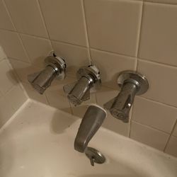 J.W. Freeman Plumbing - Improper sealing of shower knobs. The one on the right was properly sealed; however he somehow forgot to do the other two.