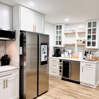 Sam's Remodeling - a kitchen with stainless steel appliances - General Contractors Near Me