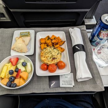 American Airlines - Business class. Included breakfast. Omelet, sweet potatoes, tomatoes, assorted fruit, and bread. Seat 5C. Airbus A321. RDU to CUN. - Airlines Near Me - Cancún, ROO