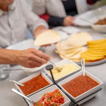 Bubbakoo's Burritos - a man putting tortillas in bowls - Mexican Near Me - Middletown, Delaware Bubbakoo's Burritos - a man putting tortillas in bowls - Mexican Near Me - Middletown, Delaware