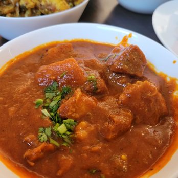 Nosh Cafe - a bowl of stew and a plate of rice - Indian Near Me - Edmonton, Alberta Nosh Cafe - a bowl of stew and a plate of rice - Indian Near Me - Edmonton, Alberta