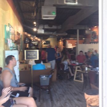 Native Cafe - People sitting on left on bench waiting for table. - American Near Me - Gulf Breeze, Florida