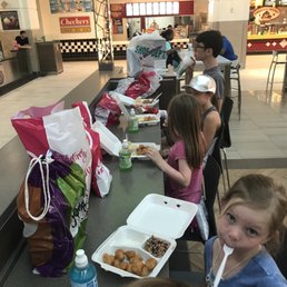 a group of children sitting at a table eating