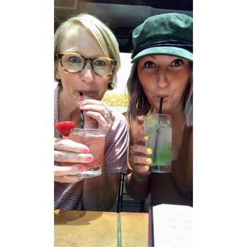 Wheat State Distilling - two women drinking a drink - Distilleries Near Me - Wichita, Kansas Wheat State Distilling - two women drinking a drink - Distilleries Near Me - Wichita, Kansas