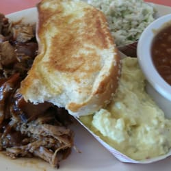 Pork plate with slaw, potato salad, and beans