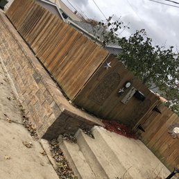 New Block retaining wall. They re-installed the fence.