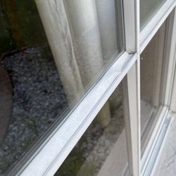 Ameriglass Contractors - Dented and damaged the white window bar while removing glass.