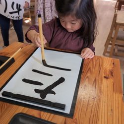 American International Montessori - Calligraphy lesson for Japanese New Year.