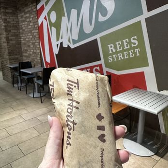 Tim Hortons - a person holding a bag of food - Coffee & Tea Near Me - Toronto, Ontario Tim Hortons - a person holding a bag of food - Coffee & Tea Near Me - Toronto, Ontario