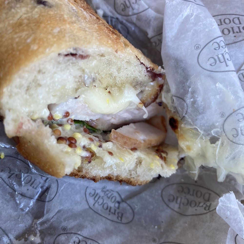 Brioche Dorée - a half eaten sandwich - Coffee & Tea Near Me - Charlotte, North Carolina