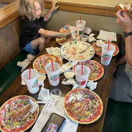 a man and child eating pizza a man and child eating pizza