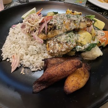 Margaritaville - Grilled Mahi-mahi-- served atop rice with an impressive medley of sautéed vegetables and fried plantains. - American Near Me - St. Thomas, Virgin Islands