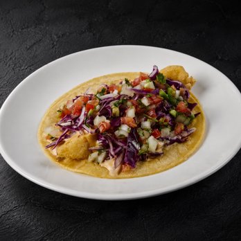 Fuego Cravings - Crispy fried fish topped with creamy chipotle sauce, fresh cabbage, and pico de gallo, all on two warm corn tortillas. - Mexican Near Me - Highland, California Fuego Cravings - Crispy fried fish topped with creamy chipotle sauce, fresh cabbage, and pico de gallo, all on two warm corn tortillas. - Mexican Near Me - Highland, California