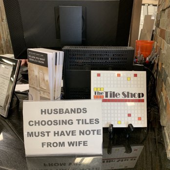 The Tile Shop - a pile of tiles and a sign - Flooring Near Me - Omaha, Nebraska