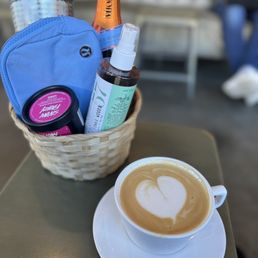 a cup of cappuccino and a bottle of tea