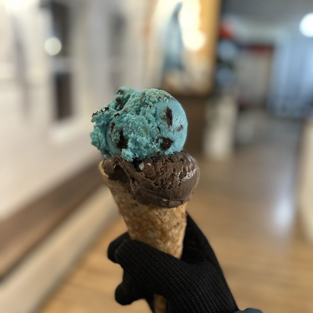 Sweet Peaks - a hand holding a cone of ice cream - Ice Cream & Frozen Yogurt Near Me - Whitefish, Montana Sweet Peaks - a hand holding a cone of ice cream - Ice Cream & Frozen Yogurt Near Me - Whitefish, Montana