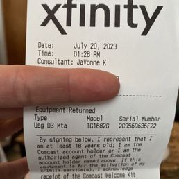 The image shows a receipt from Xfinity Store by Comcast in Troy, MI, dated July 20, 2023, at 1:28 PM. The receipt includes the consultant's name, JaYonne K, and details about equipment returned, such as model TG1682G and serial number 2C9569636F22. The receipt contains a statement about the signer's age and account authorization, along with information regarding the Comcast Welcome Kit and privacy notices.