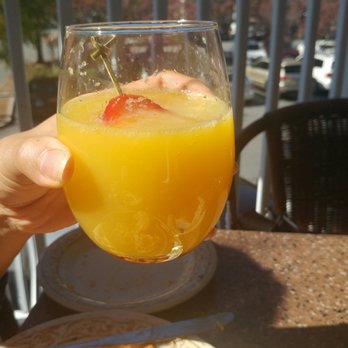 Another Broken Egg Cafe - Perfectly built Mimosa with a jumbo strawberry garnish for a bit more flavor! - Cafes Near Me - Atlanta, Georgia Another Broken Egg Cafe - Perfectly built Mimosa with a jumbo strawberry garnish for a bit more flavor! - Cafes Near Me - Atlanta, Georgia