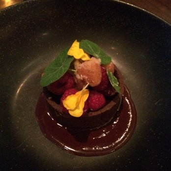 NoMI - Flourless chocolate cake with rich chocolate syrup, summer berries, and edible flowers - Bars Near Me - Chicago, Illinois NoMI - Flourless chocolate cake with rich chocolate syrup, summer berries, and edible flowers - Bars Near Me - Chicago, Illinois