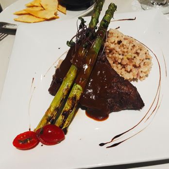 Brasa's Restaurant - My 8oz flat iron steak ($20) with grilled asparagus and a lovely onion-cilantro risotto! Delicate plating, too - Puerto Rican Near Me - Añasco, Puerto Rico