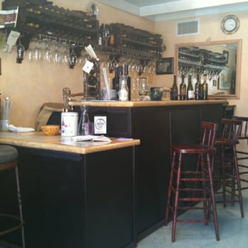 Central California Wines - a bar with wine glasses hanging on the wall - Wine Tasting Room Near Me - Santa Ynez, California