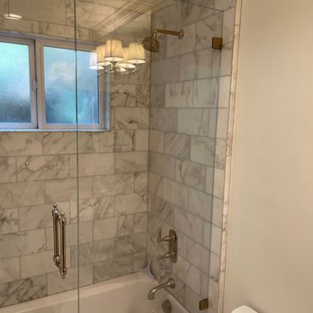 Chucks Construction - Marble tub surround, new plumbing.  New vanity, mirror and lighting not in the picture. - General Contractors Near Me