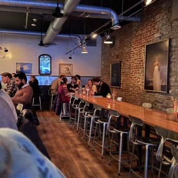 Hand And Foot - people sitting at tables in a restaurant - Bars Near Me - Corning, New York