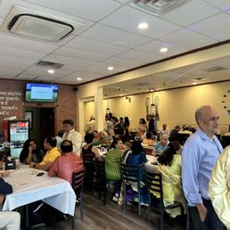 a large group of people sitting at tables in a restaurant