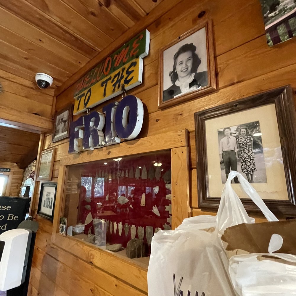 Neal's Dining Room - a wooden wall with a variety of pictures - American Near Me - Concan, Texas