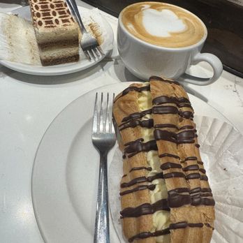 Old Europe Pastries - Tiramisu, eclair with chocolate drizzle - Coffee & Tea Near Me - Asheville, North Carolina Old Europe Pastries - Tiramisu, eclair with chocolate drizzle - Coffee & Tea Near Me - Asheville, North Carolina